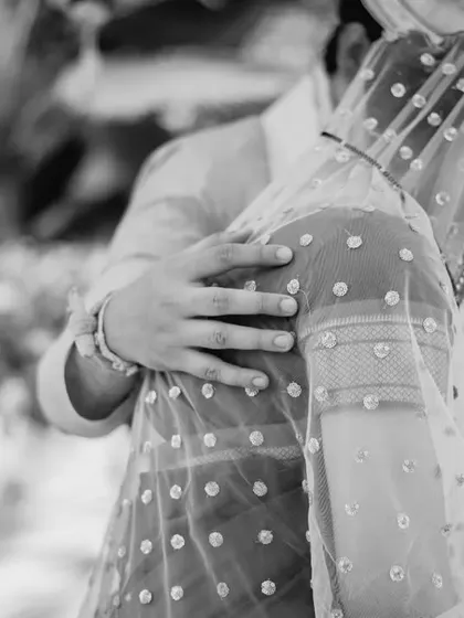A black and white shot focusing on the hands and the connection during the pheras. It’s a quiet, artistic photo that highlights the solemnity of the ritual.