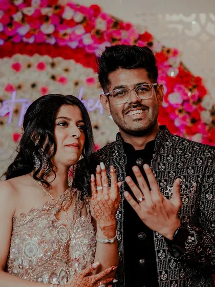 The couple proudly showing off their engagement rings. This is a classic shot that marks the official beginning of their journey to marriage.