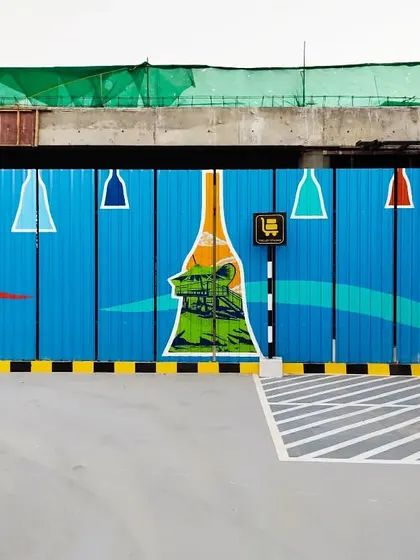 Our expansive mural for the Bangalore International Airport. Spanning a long barricade, the artwork features scenes and landmarks from across Karnataka, framed within the iconic bell shape of the terminal's design.