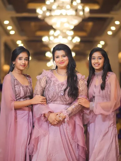 A beautiful photo of a mother with her daughters at Purvi's 5th birthday party, all dressed in matching lavender outfits.