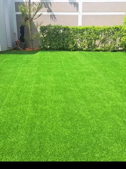 A neat backyard installation of bright green artificial turf. It instantly makes the space look clean, manicured, and ready to use.