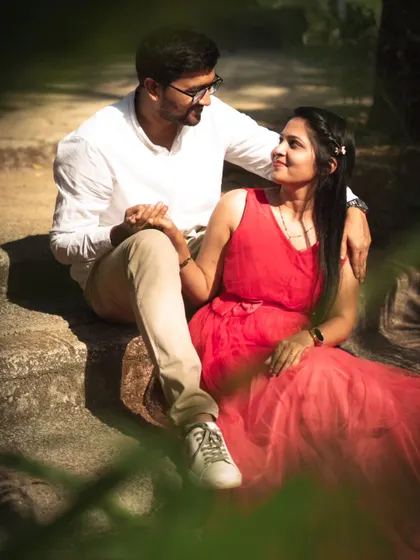 Seated on stone steps, this couple shares a look. I framed this shot through some foliage to add depth and create the feeling of peeking into a private, romantic moment.