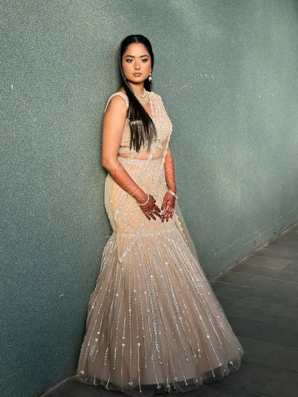 A full-length view of the bride in her stunning mermaid-style lehenga. The makeup is glamorous yet refined, completing this show-stopping look.