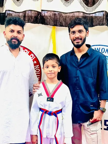 This young student is happy to receive his new red and blue belt.