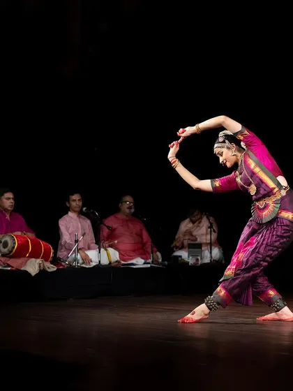 A pose that combines a strong stance with a graceful curve of the torso, showing the dynamic yet fluid nature of the dance.