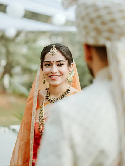 A beautiful moment between the bride and groom. Her radiant smile and the simple, elegant makeup create a look of pure happiness.