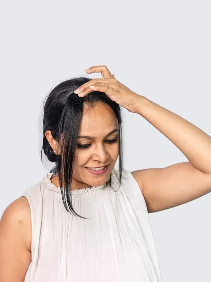 This image demonstrates the application of a Face Framer. The piece is clipped in at the hairline to add subtle volume and shape right where you need it.