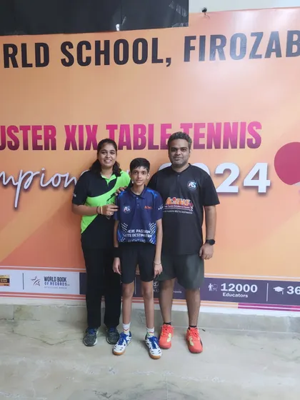 Another one of our individual medalists from the CBSE Cluster tournament posing with his coaches.