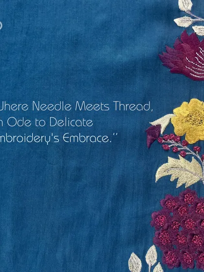 Admire the meticulous craftsmanship in every thread. This image showcases a variety of floral embroidery styles on a rich blue fabric.