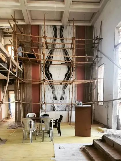 A photo from the Afsar Sheikh residence in Nagpur during construction. It shows the installation of a dramatic, book-matched marble feature wall, giving a glimpse into the luxurious material palette we use in our interior projects.