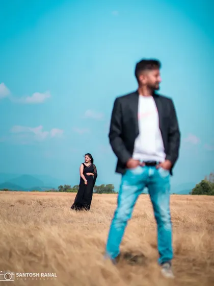 An artistic outdoor pre-wedding shot with a strong sense of depth and landscape.