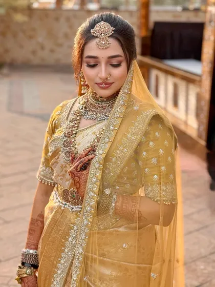 A moment of quiet reflection. Nischaya's makeup is designed to look stunning from every angle, with soft contouring and highlighting that catches the light beautifully.