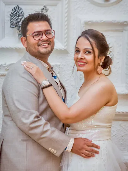 A classic posed portrait from an engagement party. The couple looks elegant and happy, ready to celebrate with their family and friends.