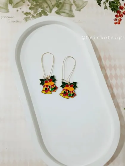 Jingle all the way with these Christmas bell hoop earrings. The colorful enamel and holly details are so charming.