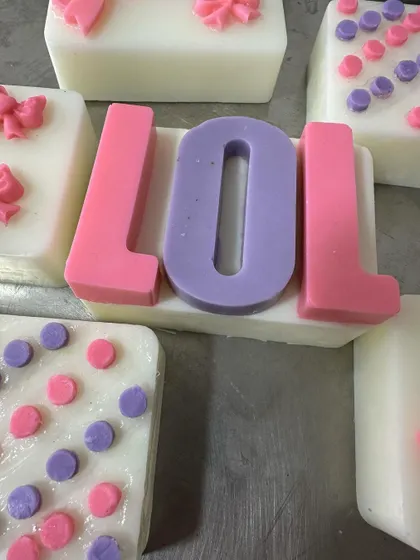 A close-up of the 'LOL' soap, a popular choice for themed birthday party favors.