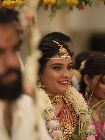 A candid shot from the wedding ceremony, capturing the bride's happy and radiant expression.