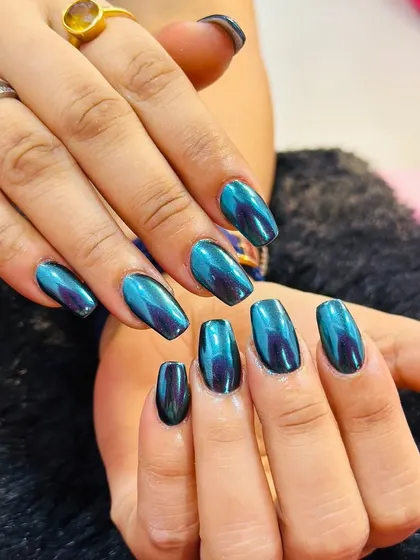 A stunning example of a duochrome finish, these nails shift from a deep teal to a rich purple. The high-gloss, metallic effect is incredibly eye-catching and perfect for a bold statement.