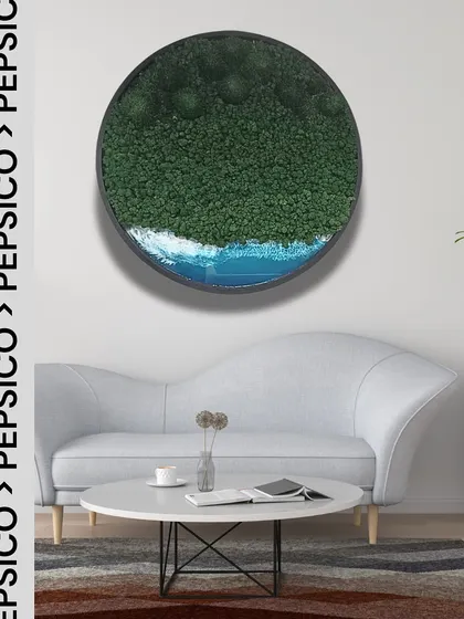 This circular resin and moss piece, shown here in a living room setting, is similar in style to the collection I created for the PepsiCo corporate project.