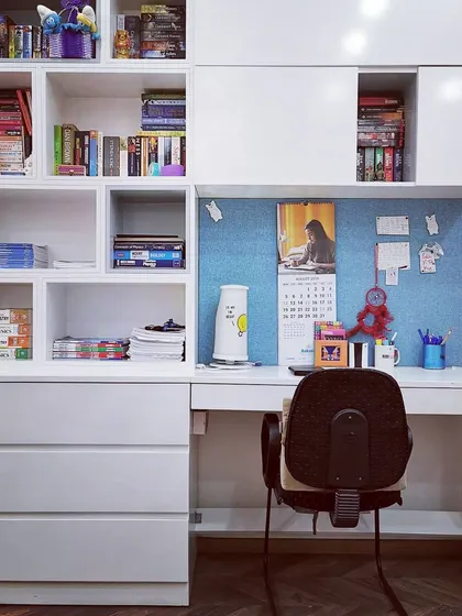 A custom-designed study and storage unit in a child's room at Villa 9/21B. This built-in furniture maximizes space and organization with a combination of open shelving, drawers, and a dedicated desk area.