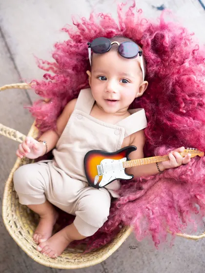 Awake and ready to rock! This little guy is all smiles with his mini guitar.
