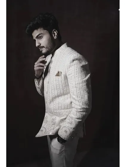 A black and white photo of the client in the embroidered off-white Jodhpuri, creating a timeless and artistic feel.