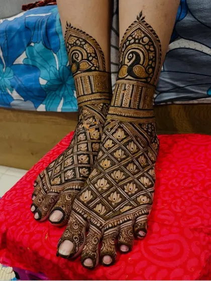 A beautiful foot design with a net pattern and peacock motifs.