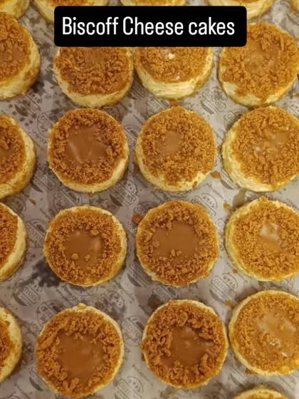 Mini Biscoff cheesecakes fill our catering tray, with biscuit crumbs spread over each individual dessert.