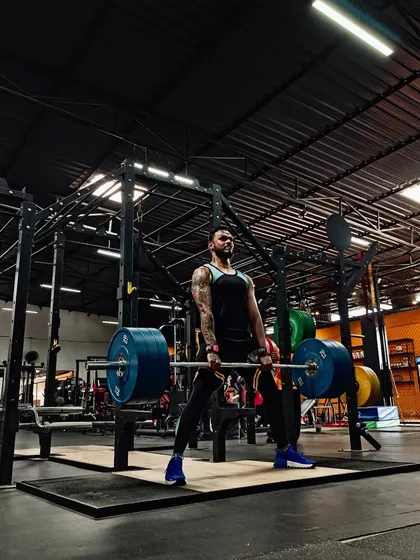 The foundation of all athletic power starts with absolute strength. Here, I'm performing a sumo deadlift, a key exercise for developing the posterior chain which is critical for sprinting, jumping, and explosive movements.