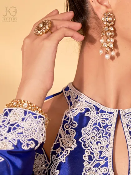 Elegance that captures the soul. This traditional look is elevated to perfection with our magnificent Polki diamond collection, featuring cascading earrings, a statement ring, and a classic bracelet.
