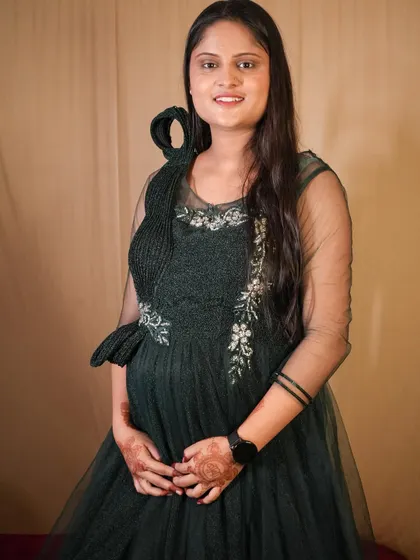 For a more modern look, this dark green gown is another great option for a maternity shoot.