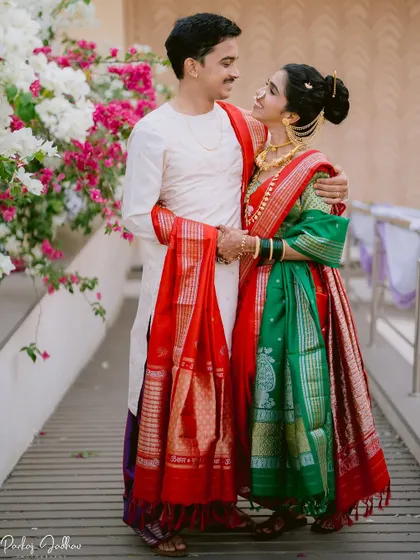 A beautiful portrait of Mugdha and Omkar, their red and green outfits creating a stunning contrast.