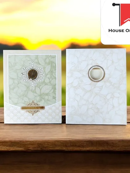 A simple and classy invitation with a green leaf pattern and a traditional emblem, with prices starting from just ₹12.