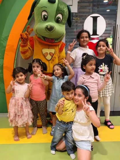 A group of friends pose with our mascot, Tinga Dojo. We love capturing these moments of pure joy and friendship.
