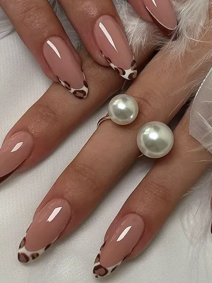 Go wild with this animal print French manicure. The design features a classic brown tip on some nails and a trendy leopard print tip on others for a bold statement.
