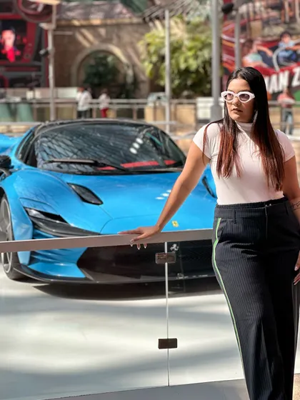 Another incredible car, another photo op. The white cat-eye sunglasses add a retro, glamorous touch to my simple outfit.