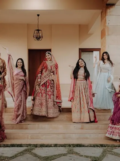 A beautiful group portrait of the bride and her bridesmaids on the steps of a grand venue.