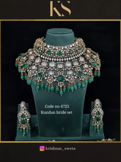 A premium quality Kundan bridal set with a classic design. The choker is adorned with uncut stones and green beads, creating a timeless look.