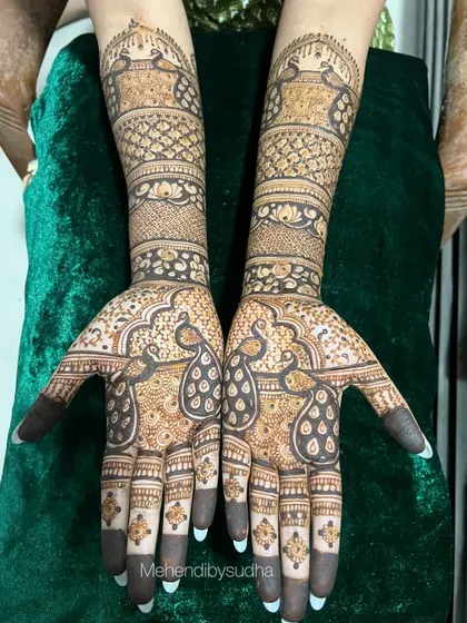 The same peacock engagement design against a rich green velvet background.
