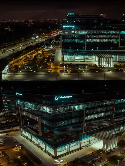 An identical high-quality night view of the Collins Aerospace building, captured with our Mavic 2 Pro drone to ensure sharp details and vibrant lighting.