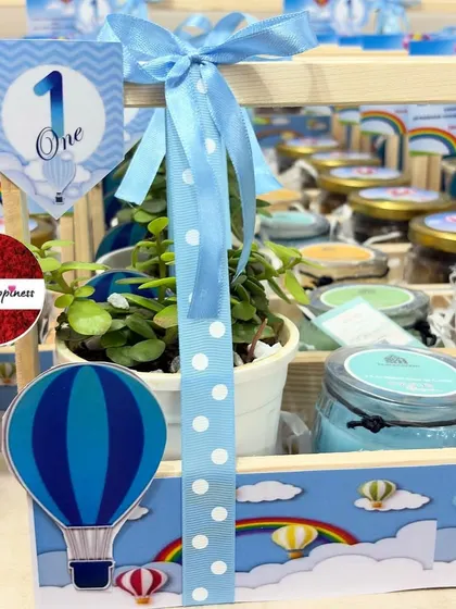 A close-up of the 'Hot Air Balloon' basket, showing the polka-dot ribbon, themed cutout, and "One" tag.