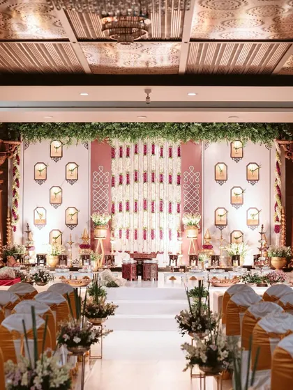 An intimate engagement ceremony where traditional motifs meet contemporary design. We created a stunning backdrop with floral strings and classic 'gopuram' niches, ensuring the setting was as special as the occasion itself.