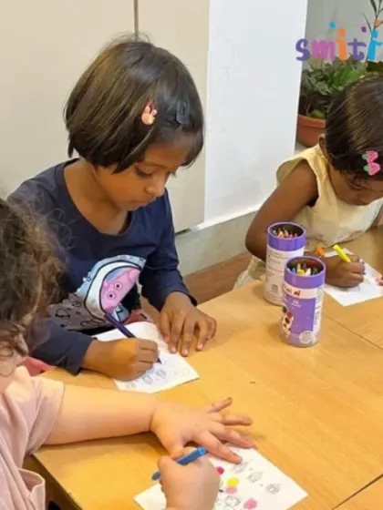 A group of children sits together at a table, each working on their own Eid-themed artwork. This fosters a sense of community while allowing for individual expression.