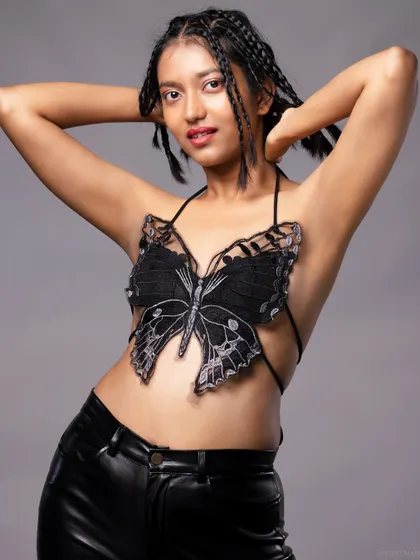 A full-body shot of the butterfly top look, paired with faux leather pants for a modern, edgy contrast.