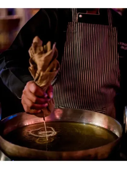 The art of making jalebis, as our chef pipes the batter into hot oil in a spiral motion.