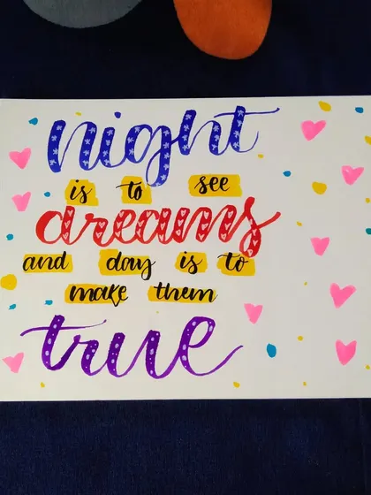 A colorful calligraphy piece with the quote "Night is to see dreams and day is to make them true."