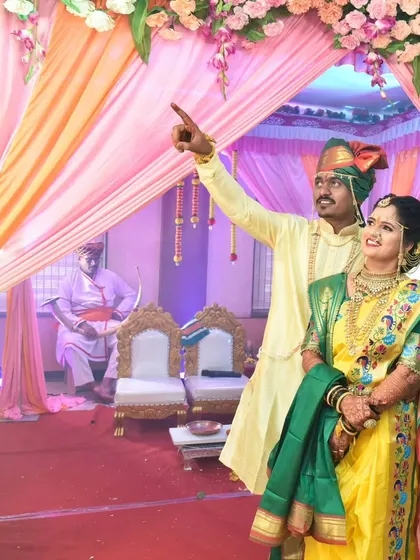 The couple stands under a beautifully decorated mandap during their wedding ceremony.