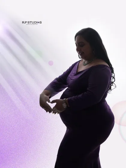 A silhouette of love. This artistic shot uses backlighting to create a beautiful silhouette, with the mom-to-be's hands forming a heart over her baby bump.