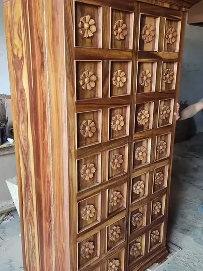 This unique wardrobe is made of solid wood with intricate floral carvings, showcasing our capability in traditional and bespoke woodworking.