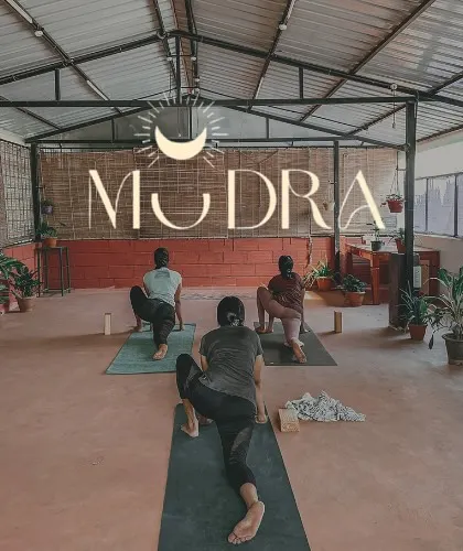 A shot of our beautiful studio space during a class. The logo overlay represents the heart of our community: Mudra.