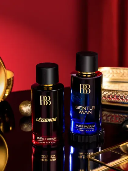 This shot for Bergamot Beaute highlights two fragrances in a luxurious setting. The composition uses golden props and a deep red background to create a sophisticated and romantic mood.